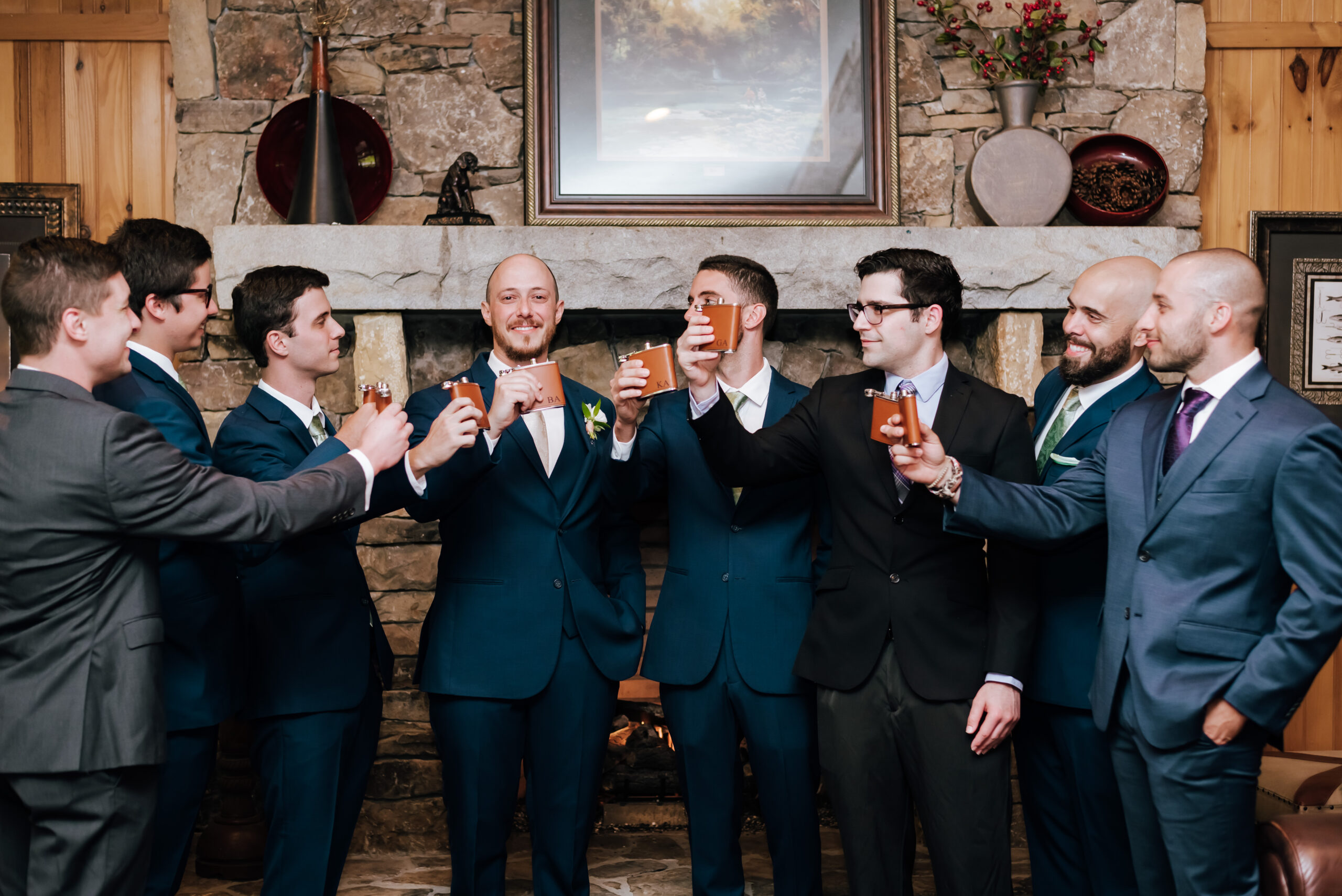 Groomsmen cheer with personalized flasks