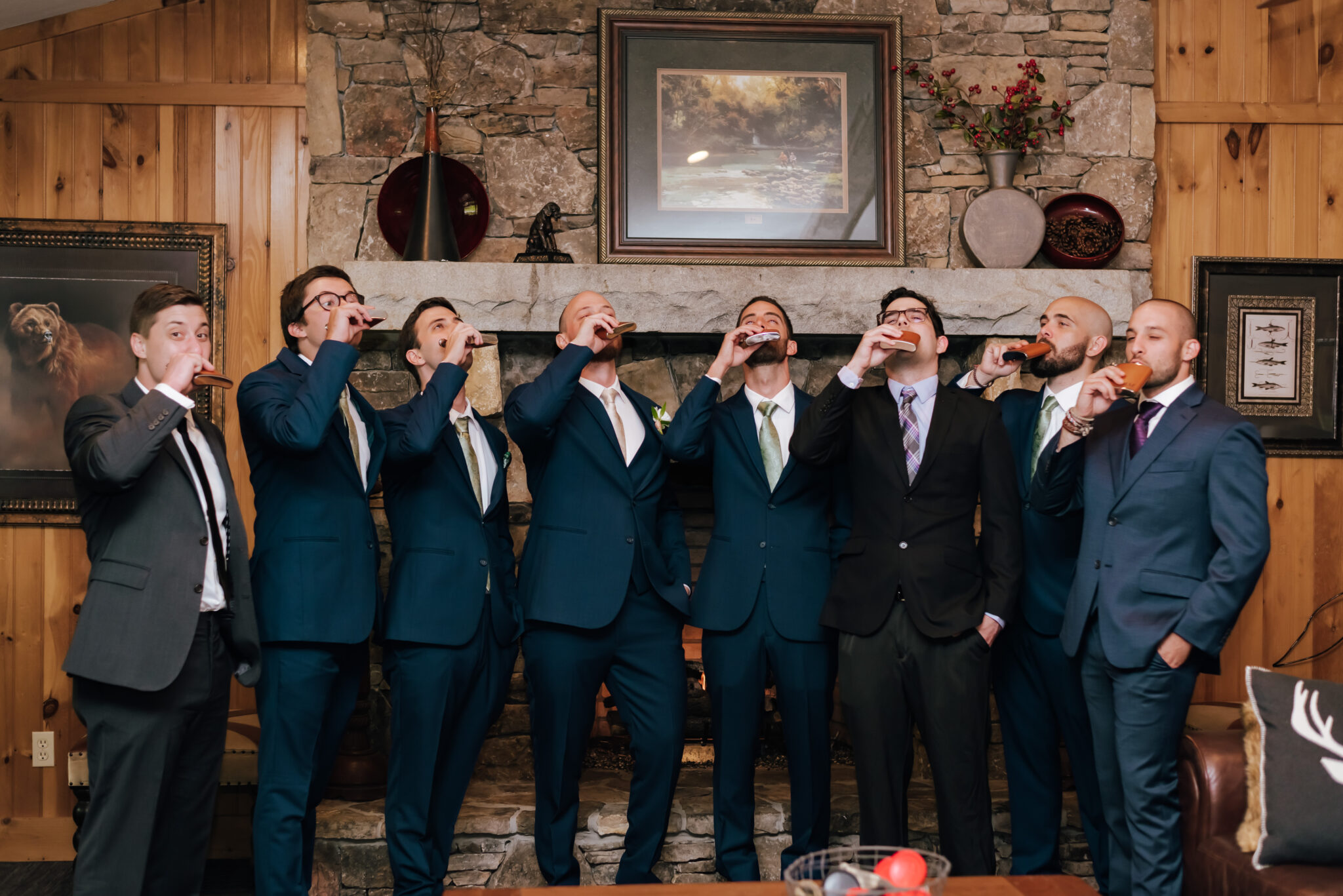 Groomsmen take a drink from their flasks