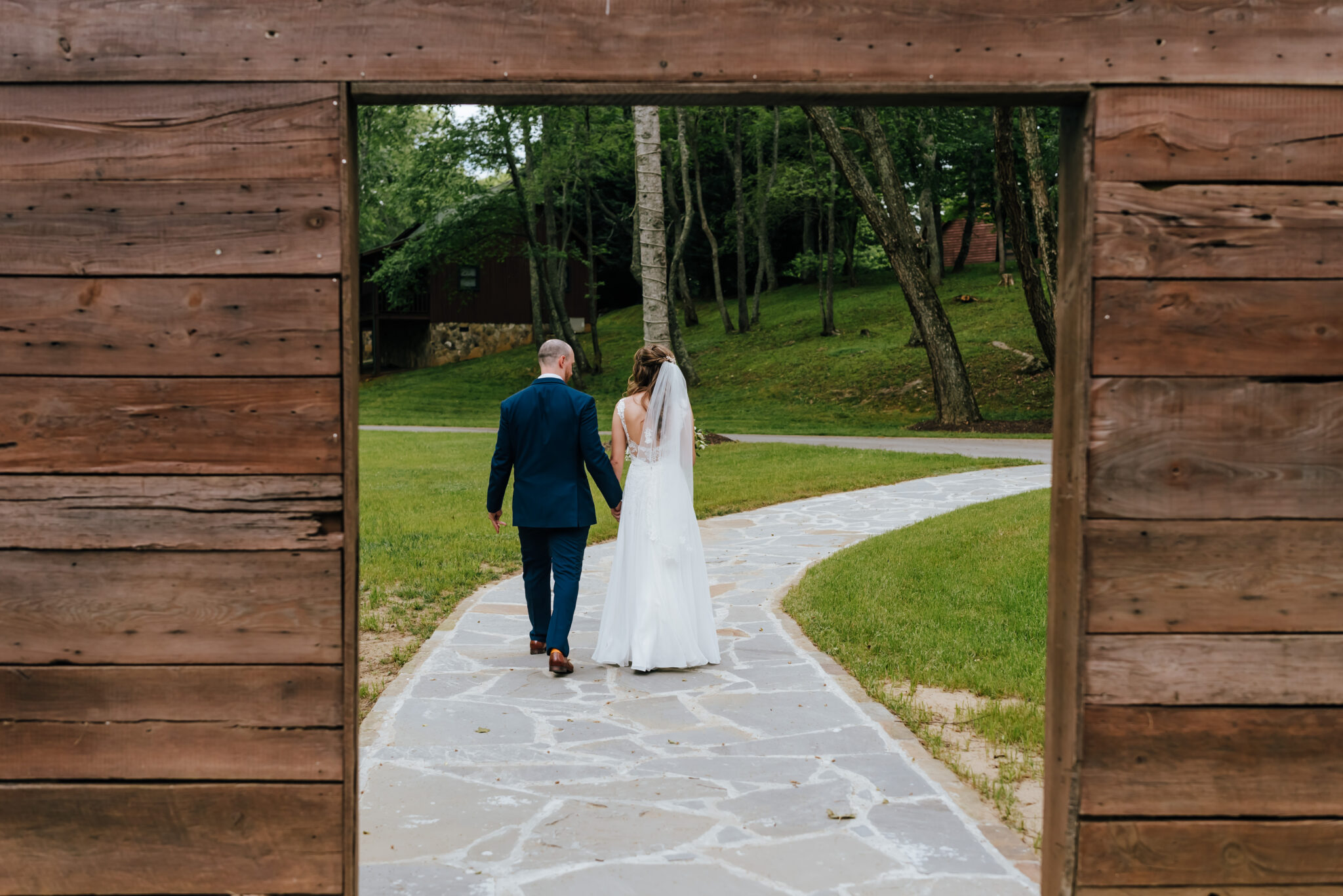 Photo from behind as bride and groom walk off into the distance