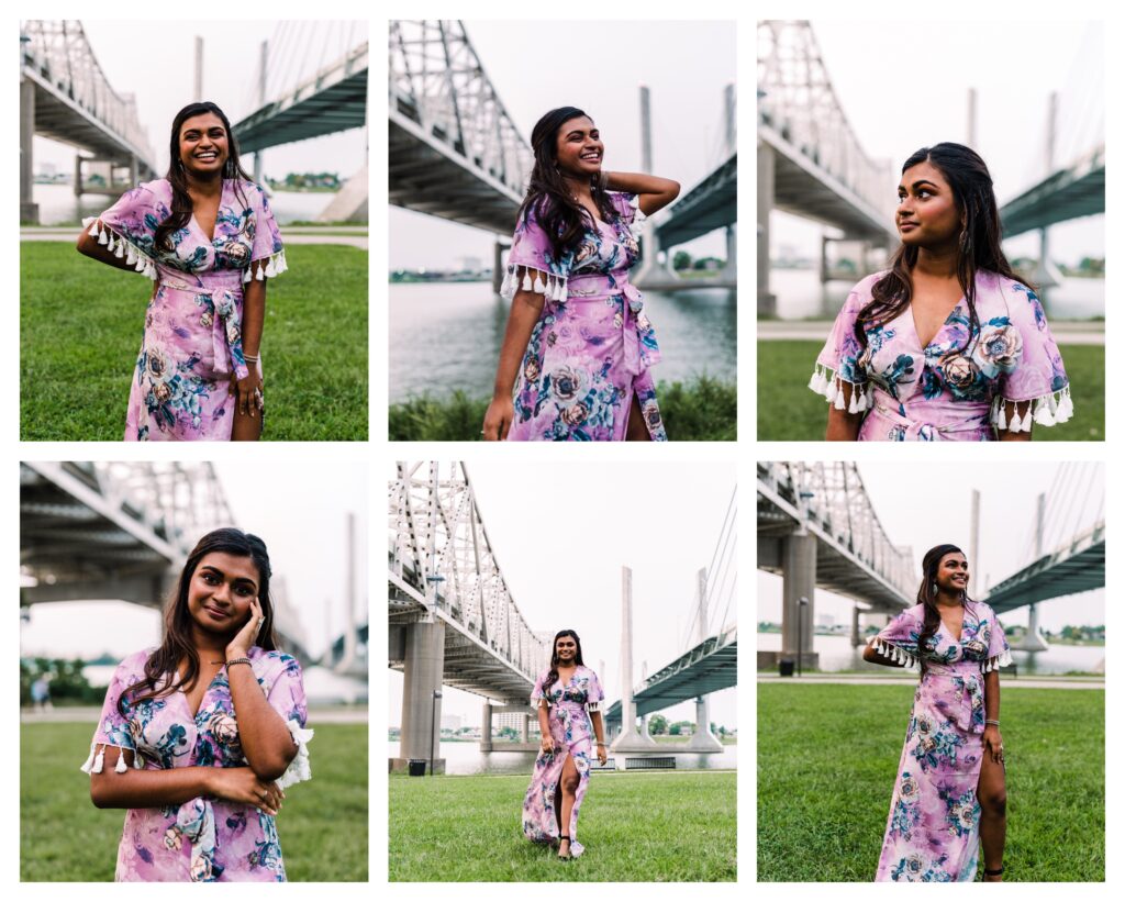 High school senior wearing a long purple dress smiles at Louisville Waterfront Park between bridges 