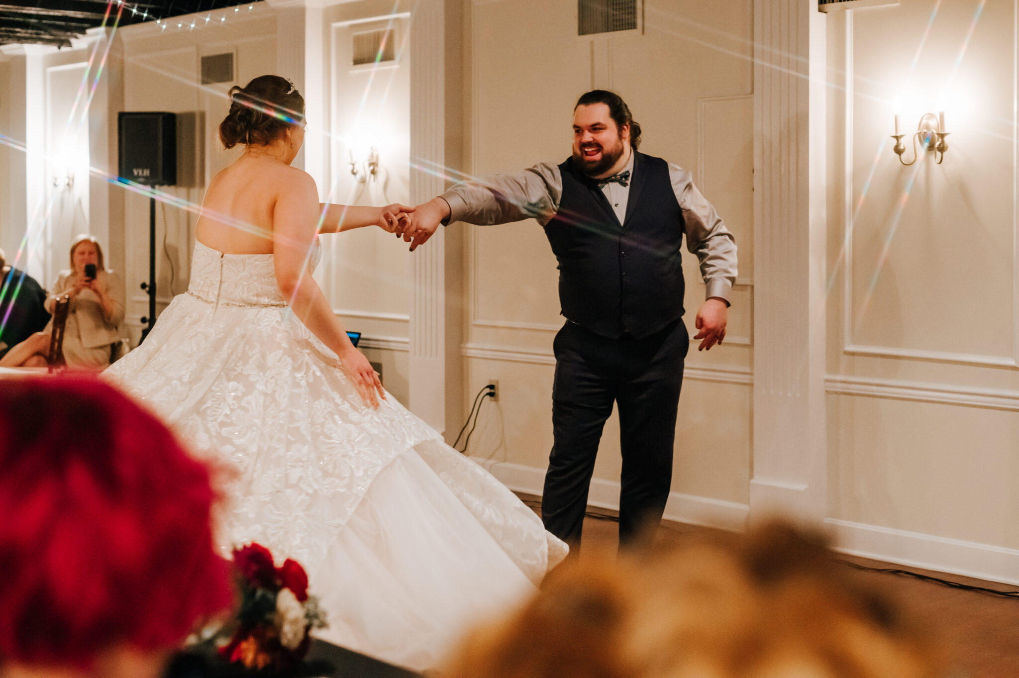 A groom spins his bride at their wedding reception