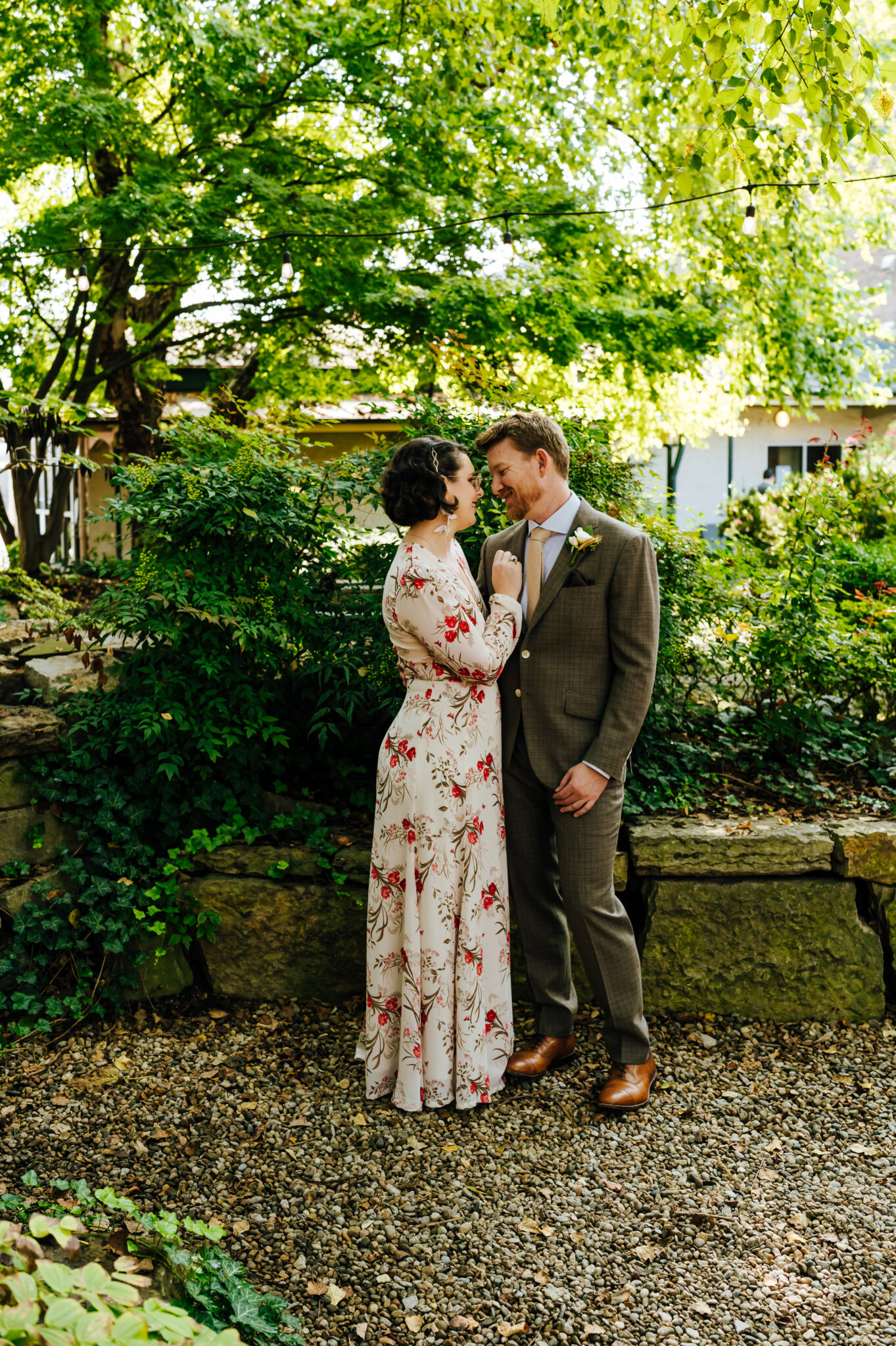 Couple embraces outdoors in a lush garden setting