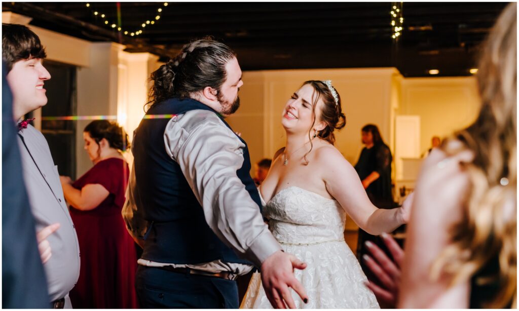 Newlyweds dance wildly and joyfully at their wedding reception