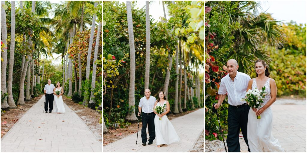 Bride walks with her father through a row of palm trees
