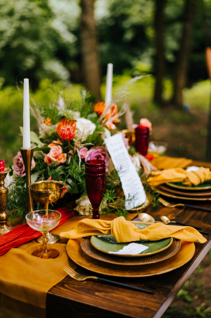 An outdoor picnic style elopement table setup with beautiful flowers
