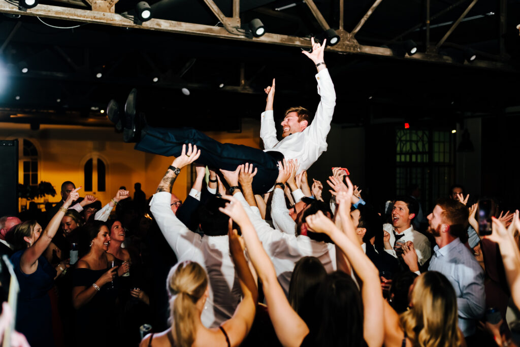 A groom crowd surfs