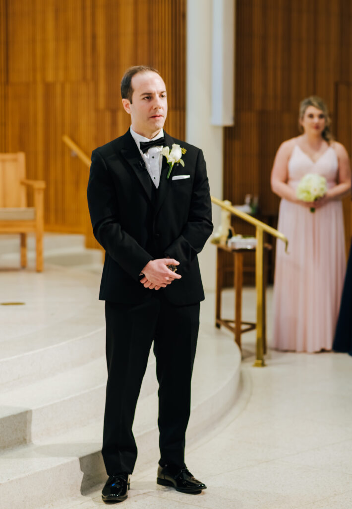 Groom stands at altar waiting for his bride
