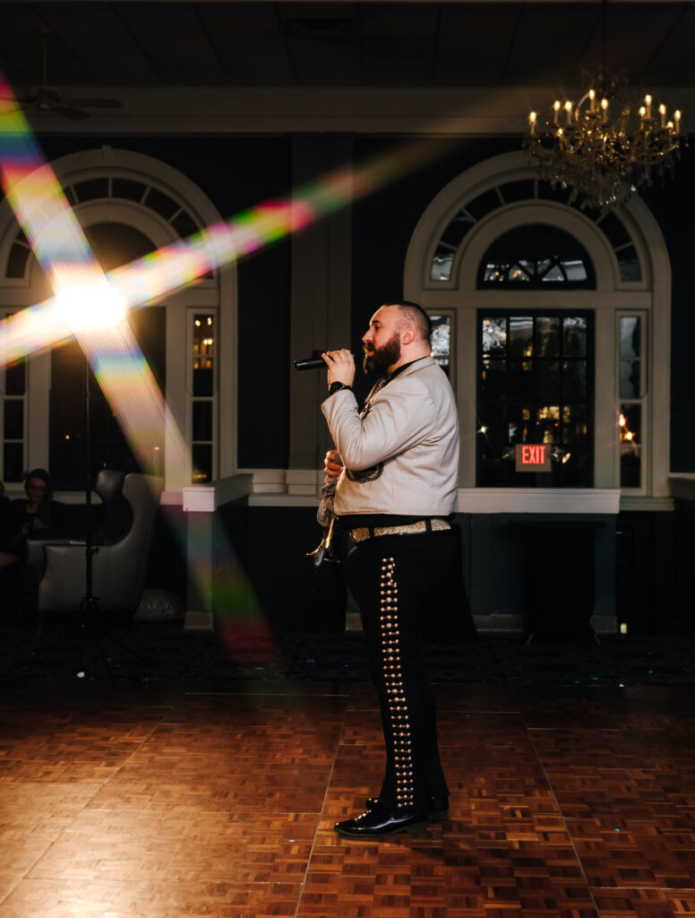 A Mariachi performer sings his heart out at a wedding reception