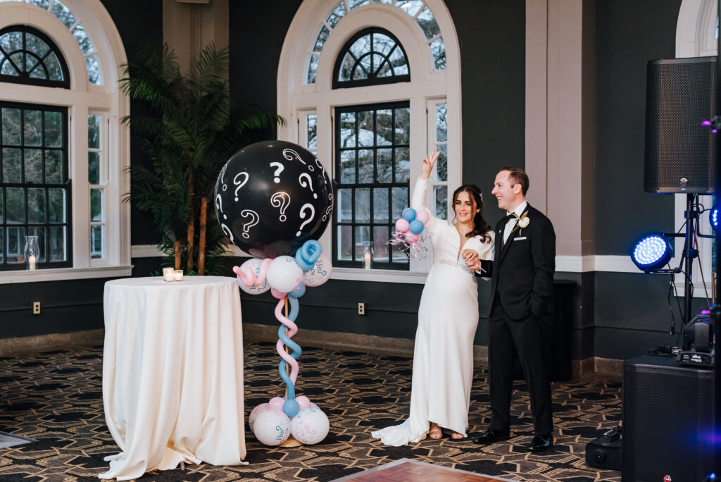 The couple gets ready to pop the gender reveal balloon