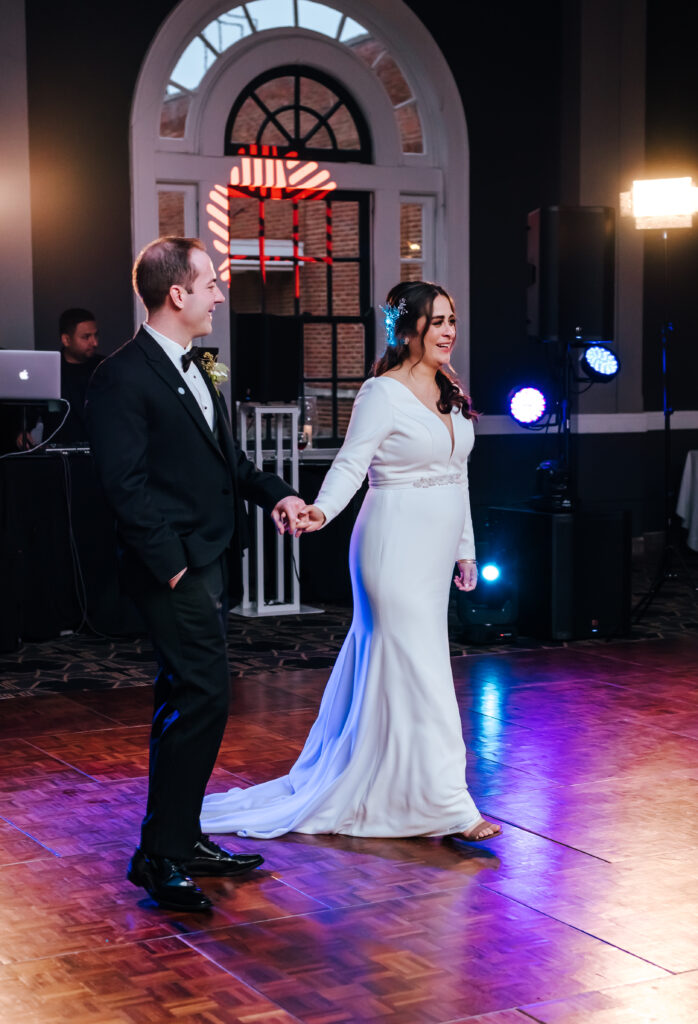 A purple glow illuminates the dance floor for the couple's first dance