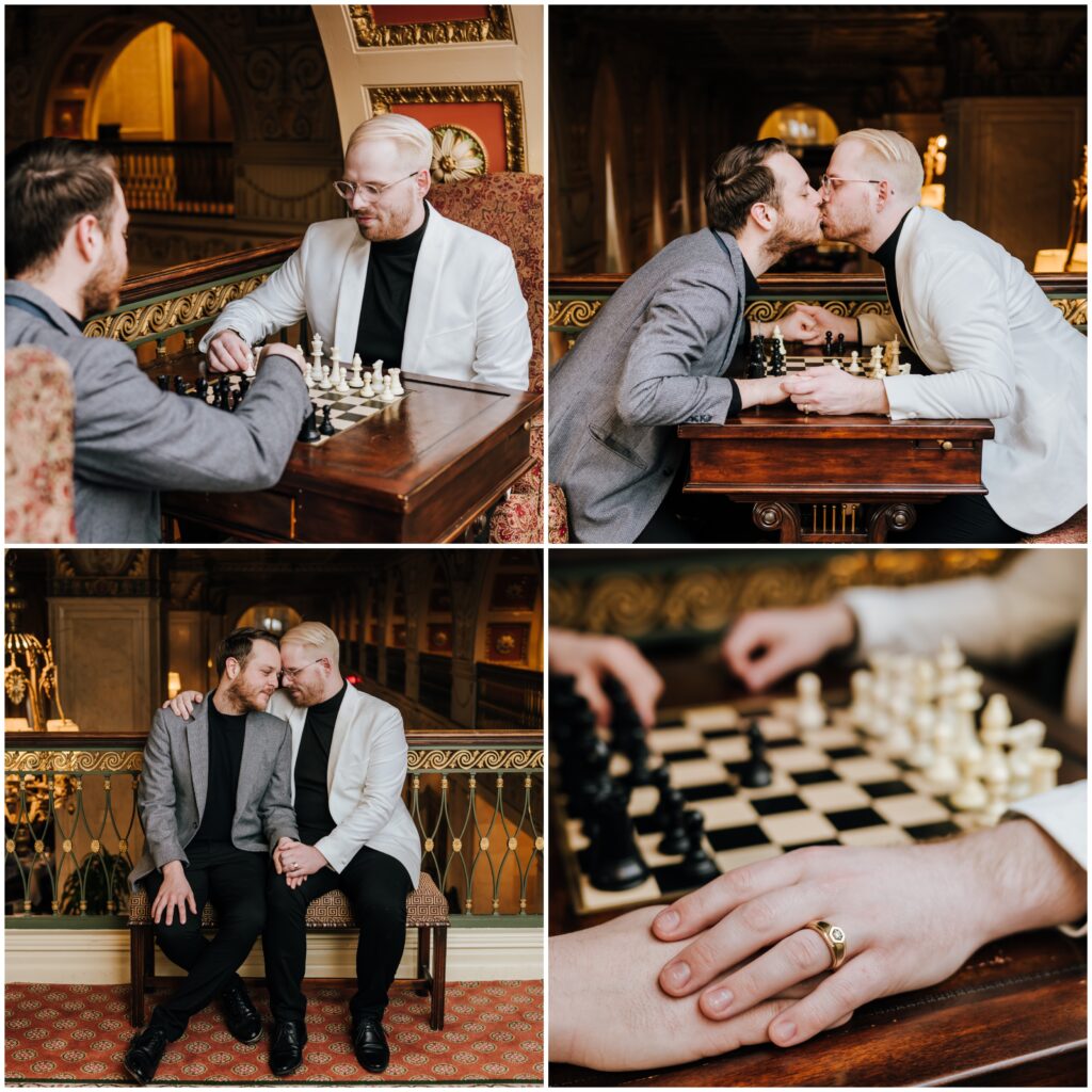 Two engaged men play chess wearing neutral colored suits in the historic Brown Hotel balcony area