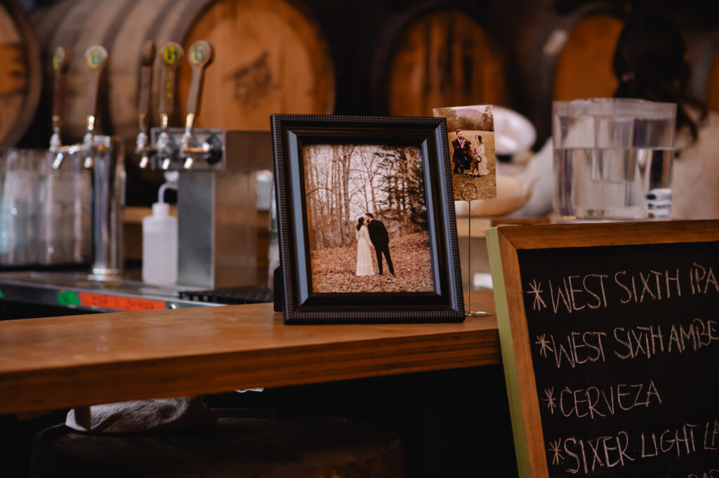 A framed wedding portrait sits atop a bar counter at West 6th Brewery Lexington