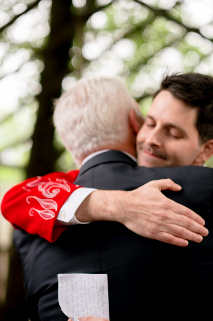 The groom hugs his father