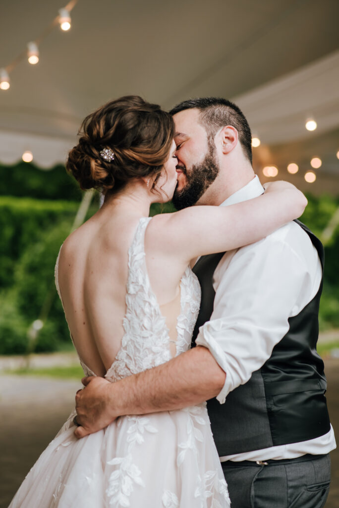 The bride and groom share a kiss for their first dance