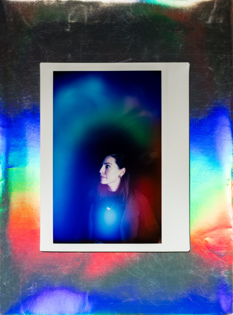 A polaroid aura portrait of a woman shows a blue glow around her