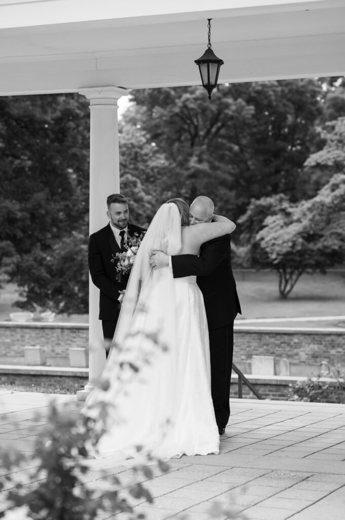 A bride shares a first look with her father and brother