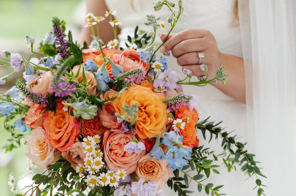 The bride appreciates her colorful bouquet