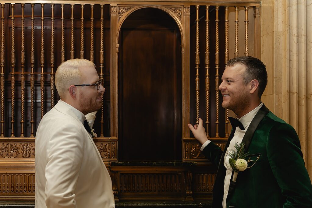 Two grooms lean against a grate in a Louisville hotel.