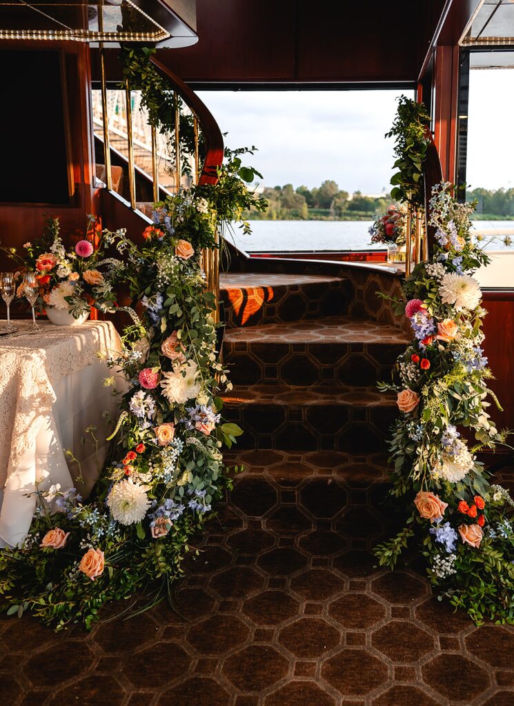 Florals line a staircase in a Louisville wedding venue.