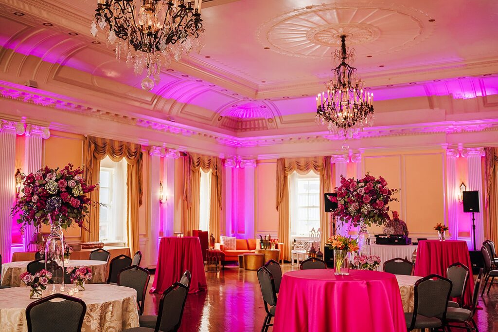 Colorful lights illuminate a ballroom in a Louisville wedding venue.