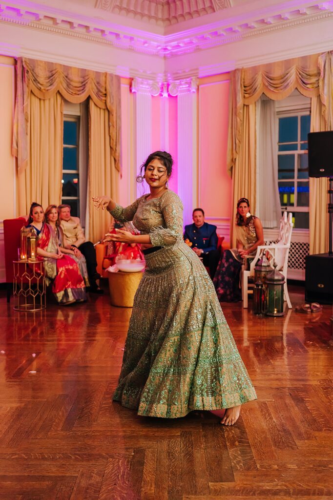 A woman performs an Indian dance during a Sangeet.