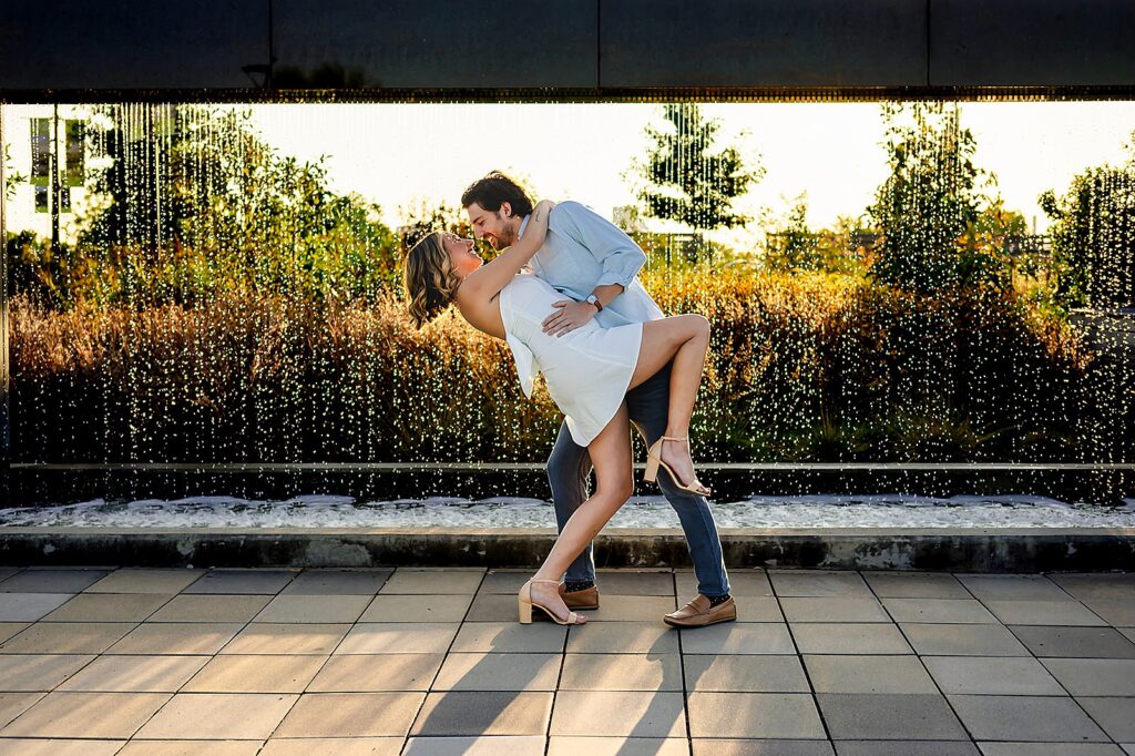 A groom dips a bride for a kiss at a botanical garden wedding in Louisville.