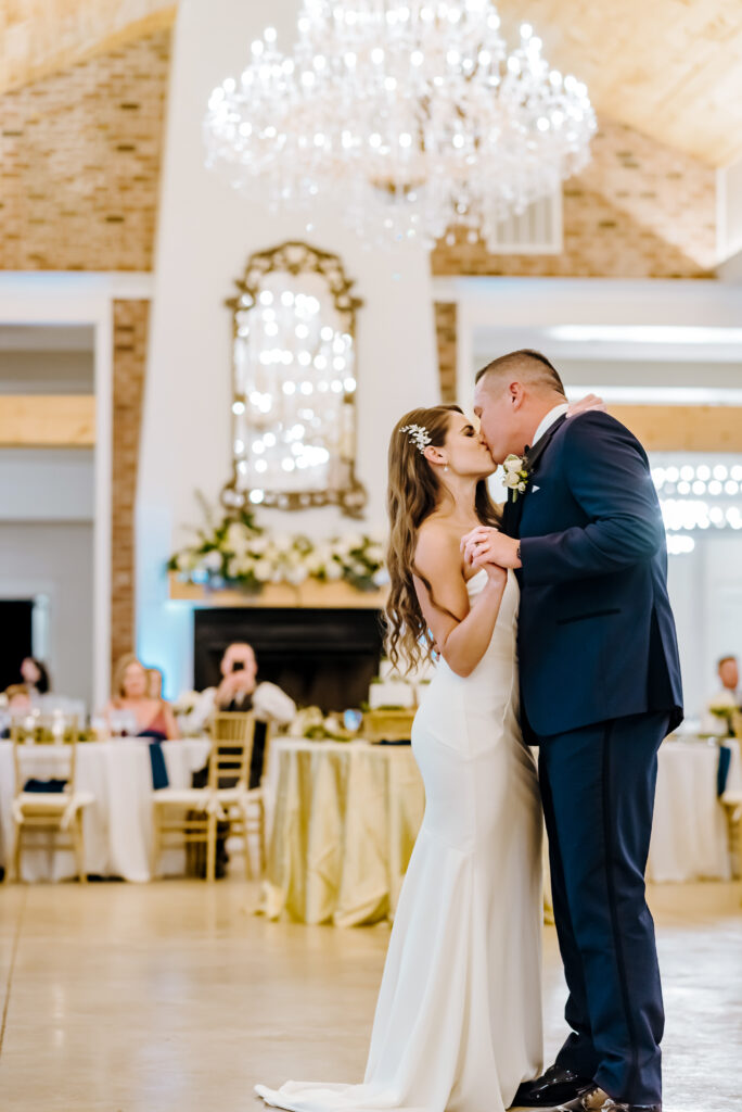 The bride and groom share a kiss during their first dance in the grand ballroom at Hazelnut Farm 