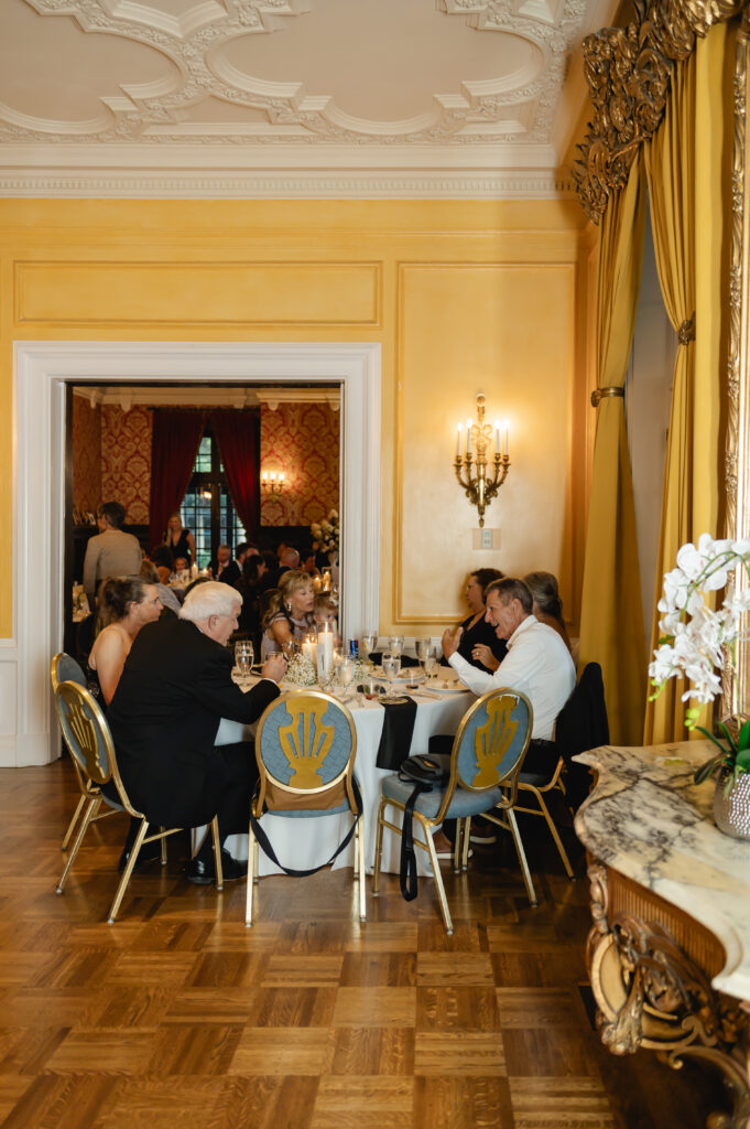 A sunny yellow room inside Gardencourt is one of the many spaces where guests can be seated during the reception