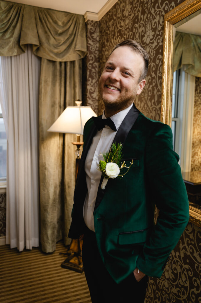 A portrait of the groom in his emerald green tux jacket.