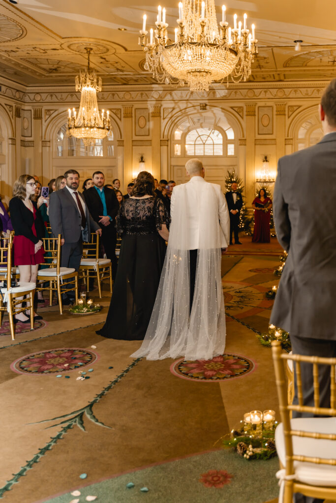 A photo from the back of the aisle as Jared and Matthew's mother walk towards the altar