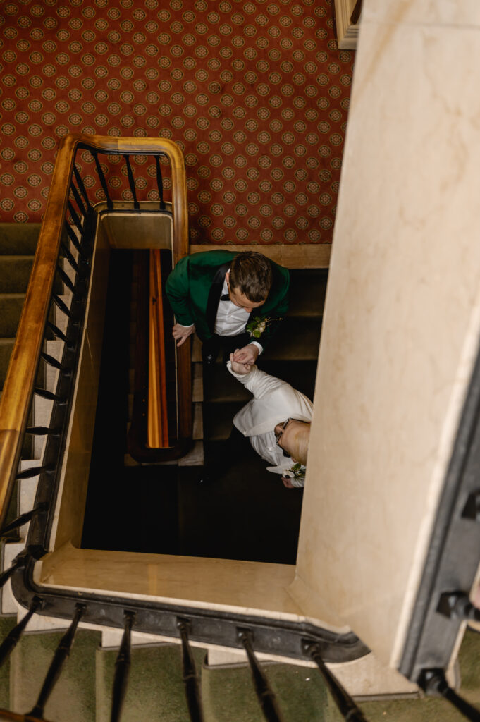 An aerial photo from the staircase shows Jared holding Matthew's hand as they walk down the staircase