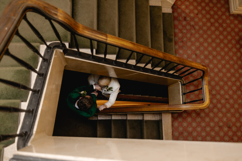 An aerial photo from the staircase shows Jared kissing Matthew's hand as they walk down the staircase