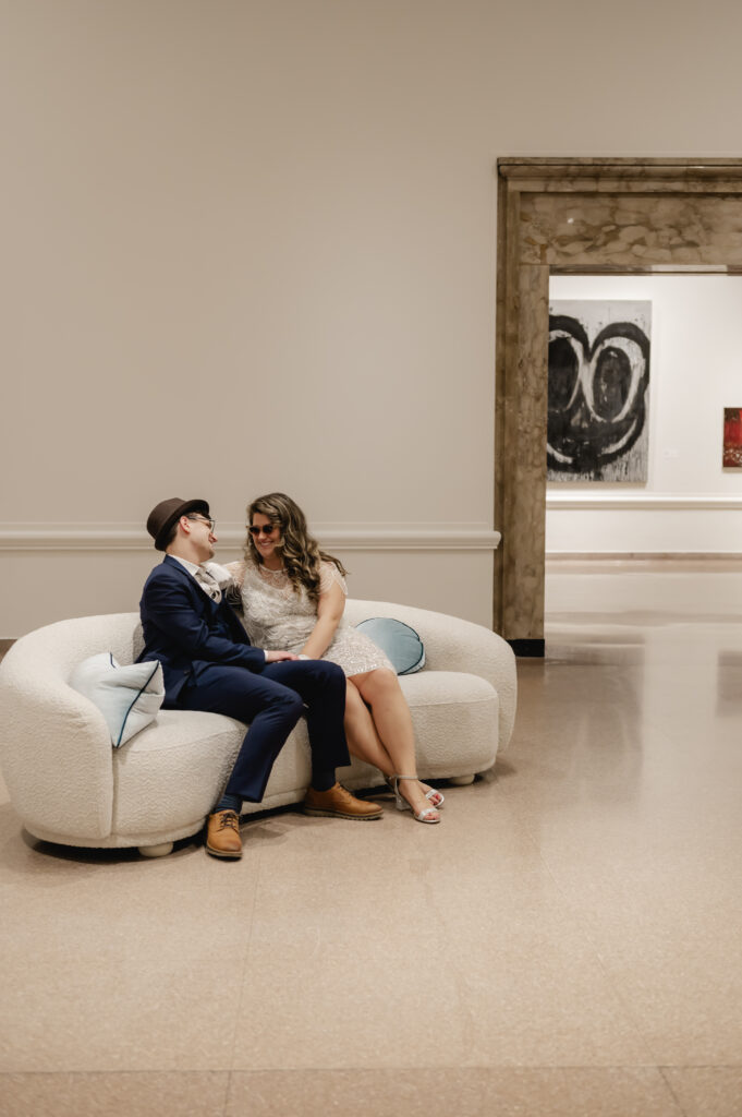 The newlyweds share a private moment in the art gallery.