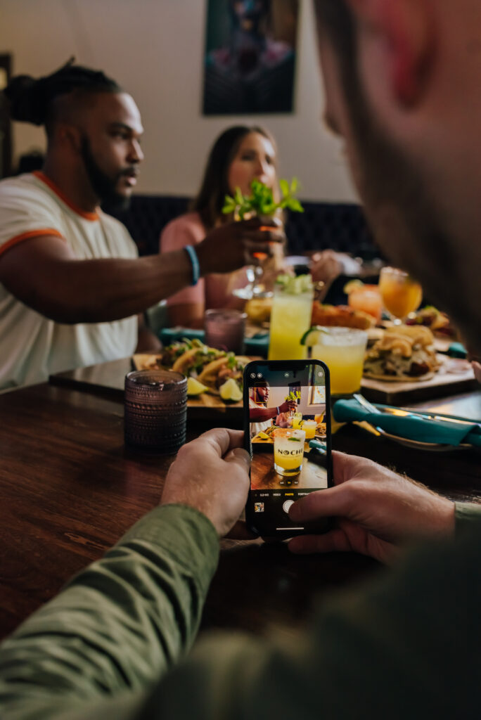 Someone takes a photo of their food at a restaurant