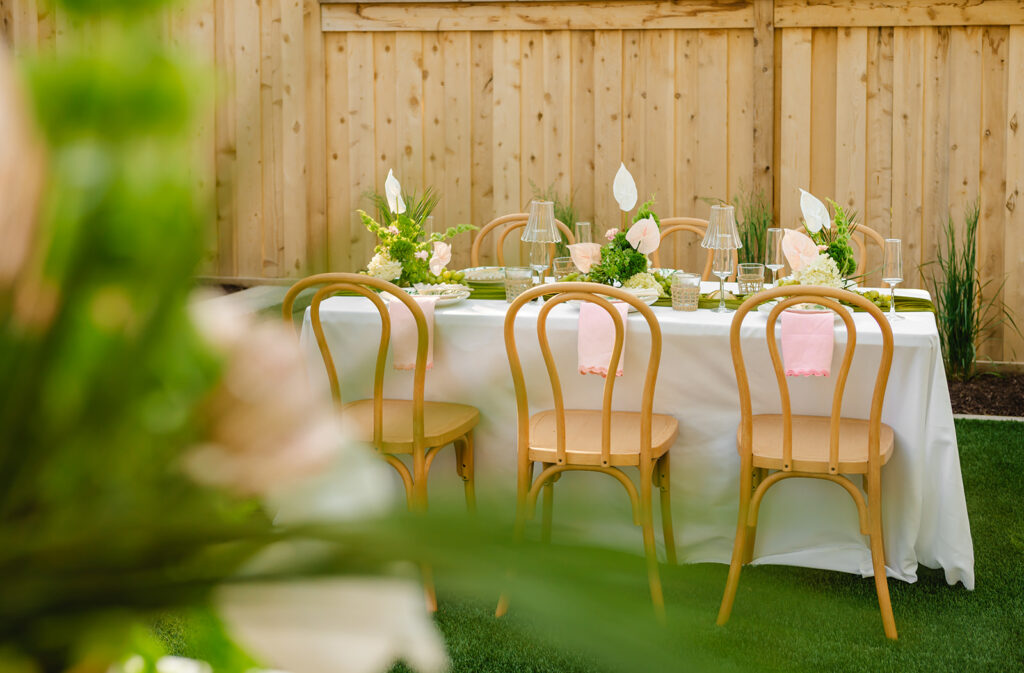 A tablescape set up for a Palm Royale themed event