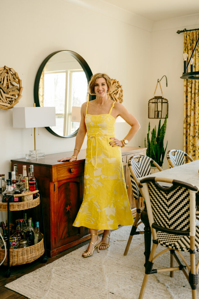 An in-home lifestyle brand photo of a wardrobe stylist in a yellow dress